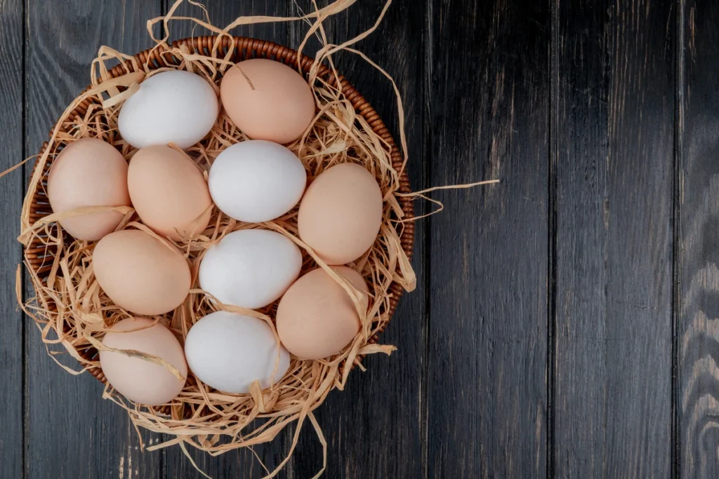 fresh eggs on a plate, highlighting the nutritional content and cholesterol discussion