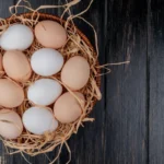 fresh eggs on a plate, highlighting the nutritional content and cholesterol discussion